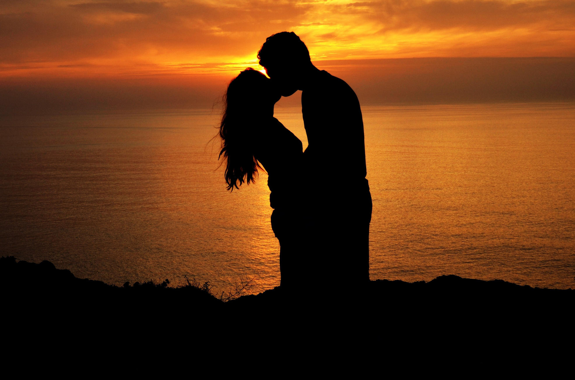 Silhouette of Lovers Kissing at Sunset